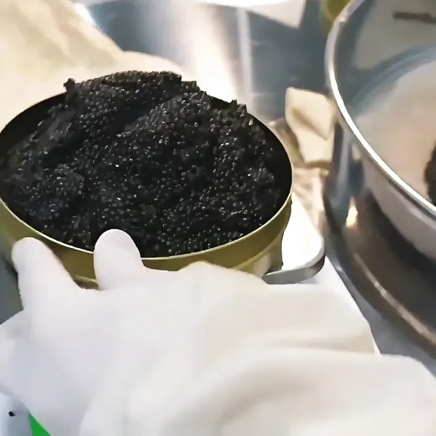A tin being filled and weighed