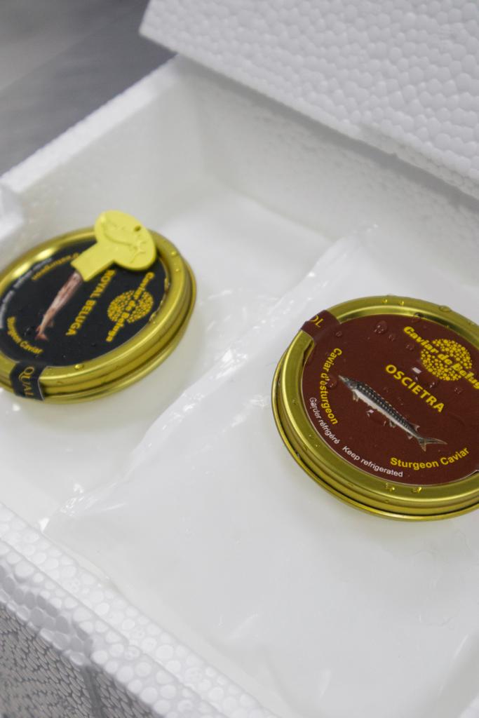 Royal Beluga and Oscietra tins in insulated styrofoam packaging for cold-chain delivery